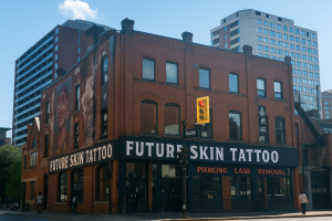 Future Skin Tattoo shop in a brick building features a large mural and a traffic light showing red.