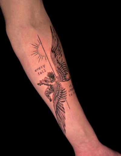 Forearm displays a tattoo of a winged cherub with the text 'every fall is chance to rise' and a sunburst design.