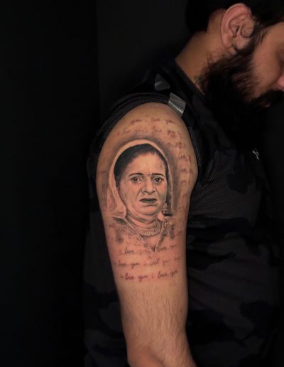 Tattoo portrait of a woman on an arm with "I love you" text