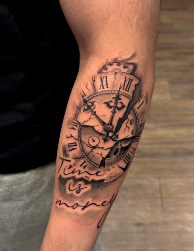 Broken clock tattoo with Roman numerals and "Time is money" text