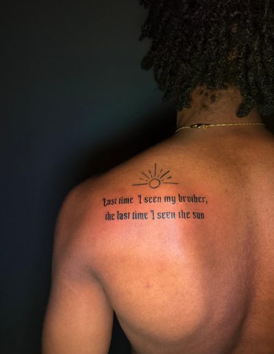 Tattoo of sun and text: "last time I seen my brother, the last time I seen the sun