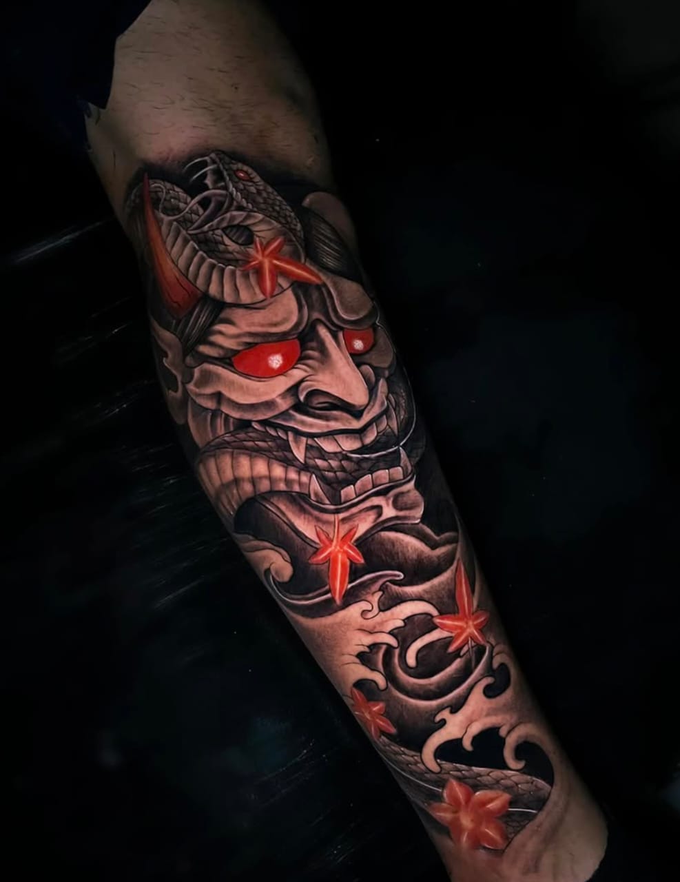 irezumi-style-hannya-mask-snake-and-red-maple-leaves-arm-tattoo Realistic lion tattoo on hand, roaring with sharp teeth and glowing eyes.